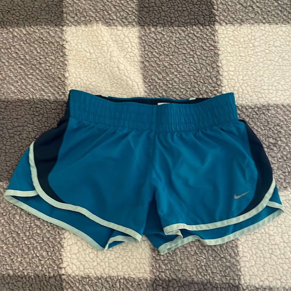 Blue Nike running shorts.